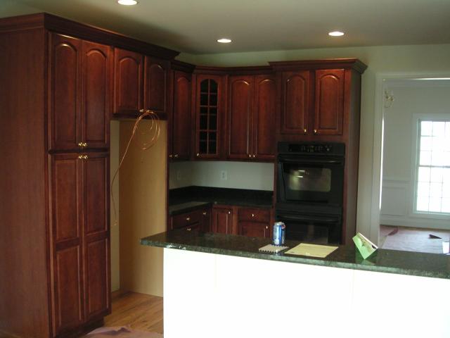 Looking into kitchen from morning room into kitchen with Pantry on left and place where fridge will be, double wall ovens also v