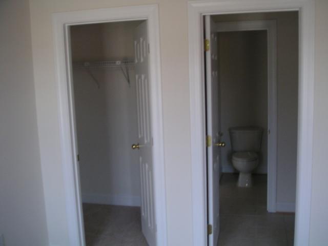 Bedroom 4 (front left of house) looking into walk-in closet and the "jack-n-jill" bathroom, there is a sink ri